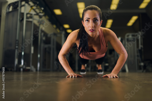 Attractive young female working out at the gym