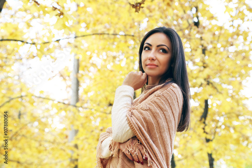 Beautiful young girl in a park in autumn, outdoors