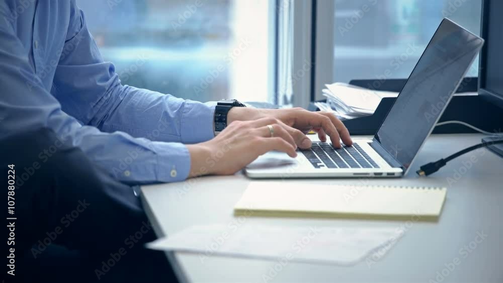 Man's hands typing on laptop keyboard Man's hands typing on laptop keyboard