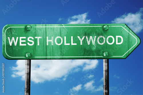 west hollywood road sign , worn and damaged look