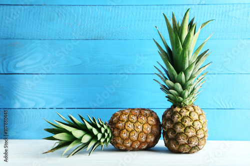 Ripe pineapples on a white wooden table