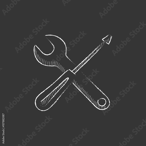 Screwdriver and wrench tools. Drawn in chalk icon.