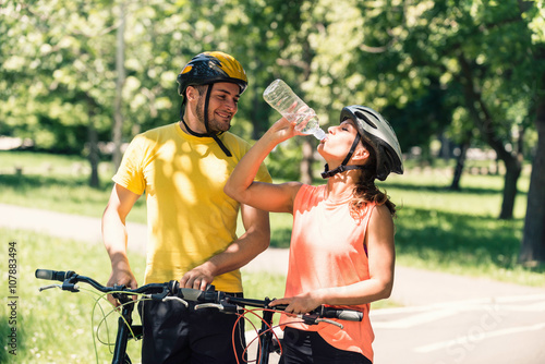 Active young couple taking a break after bicycle ride