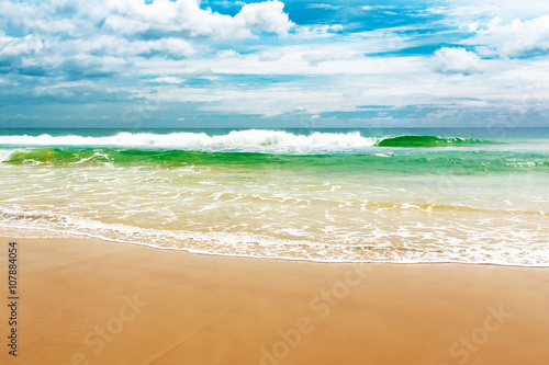 Fototapeta Naklejka Na Ścianę i Meble -  Sandy beach and turquoise ocean waves.