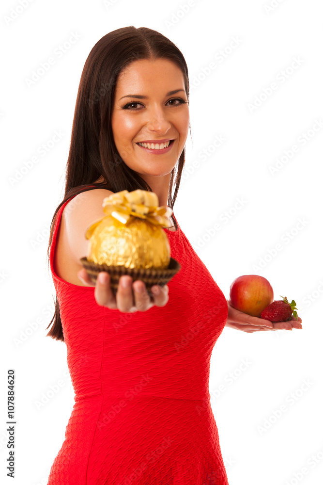 Woman deciding to eat healthy fruit or chocolate candy. Woman deciding to eat healthy fruit or chocolate candy.