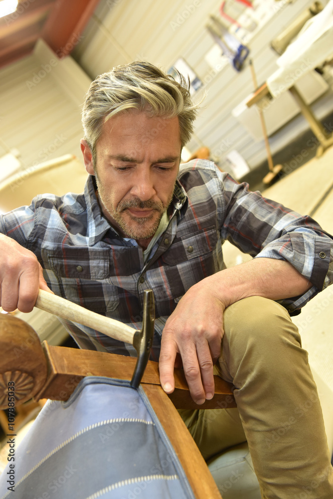 Man working in upholstery workshop Man working in upholstery workshop