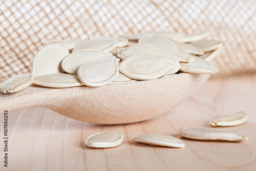 Pumpkin seeds in the wooden spoon Pumpkin seeds in the wooden spoon