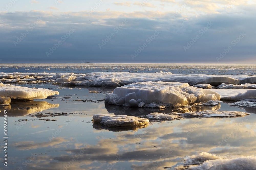 blocks of ice are thawing on the sunset lights in the spring evening blocks of ice are thawing on the sunset lights in the spring evening