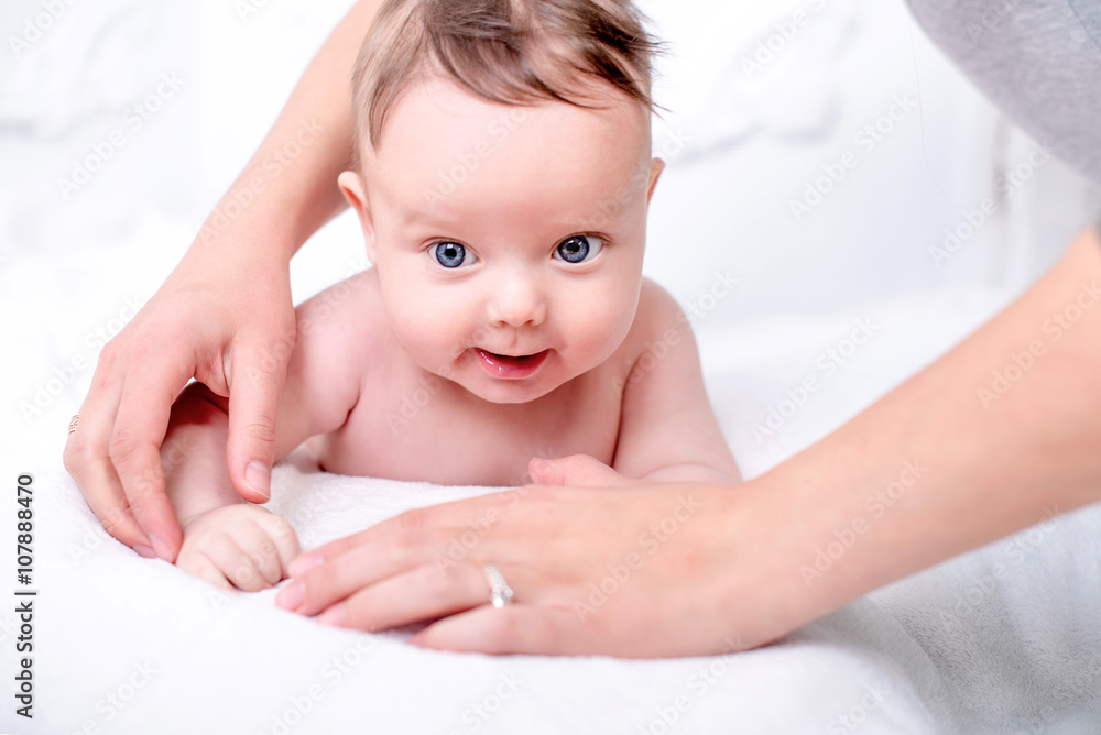 A cute little naked baby on the white wall. A cute little naked baby on the white wall.