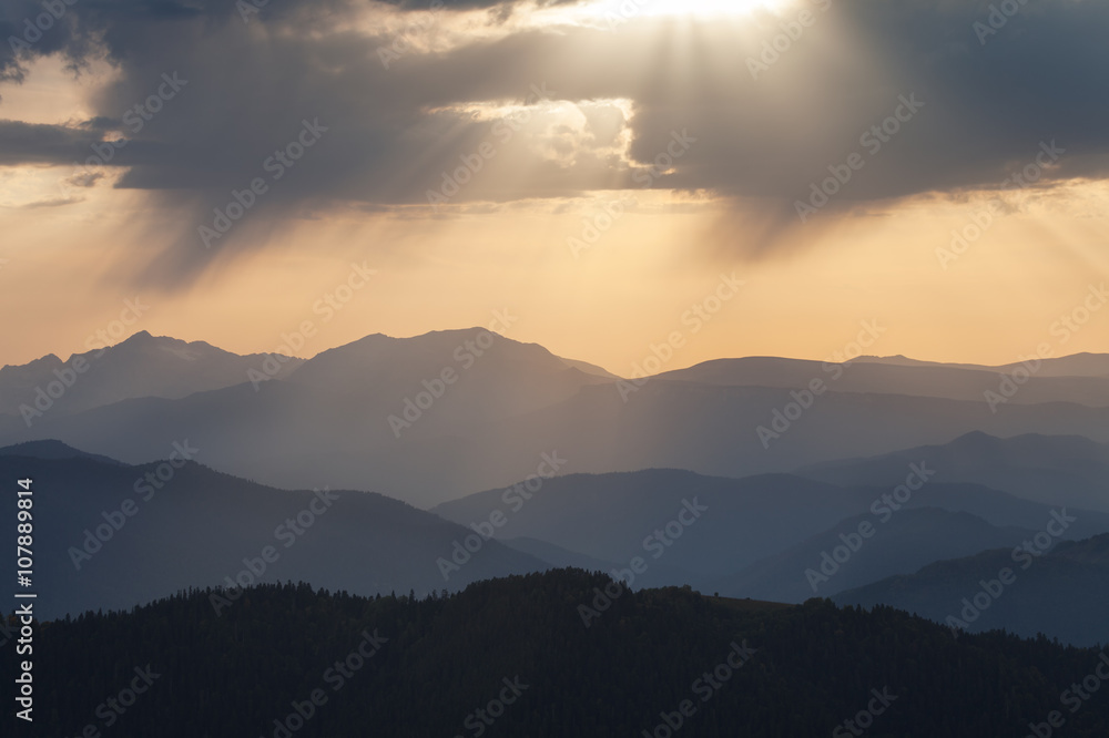 Mountain ridges at sunset against the sky with clouds Mountain ridges at sunset against the sky with clouds