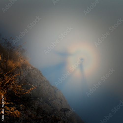 Silhouette of a man with a rainbow in the clouds