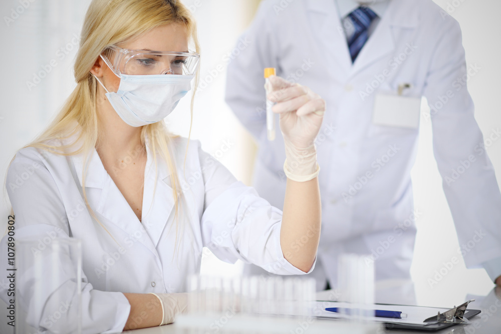 Scientific research team with clear solution in laboratory Scientific research team with clear solution in laboratory