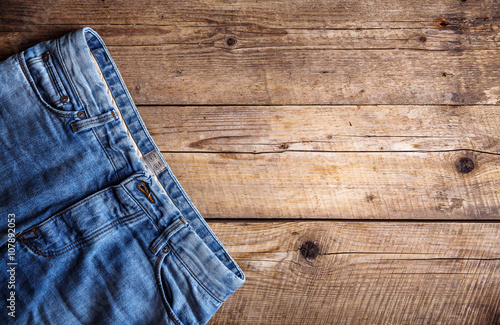 Jeans on a wooden background. The upper part. Clothing, fashion, style, lifestyle
