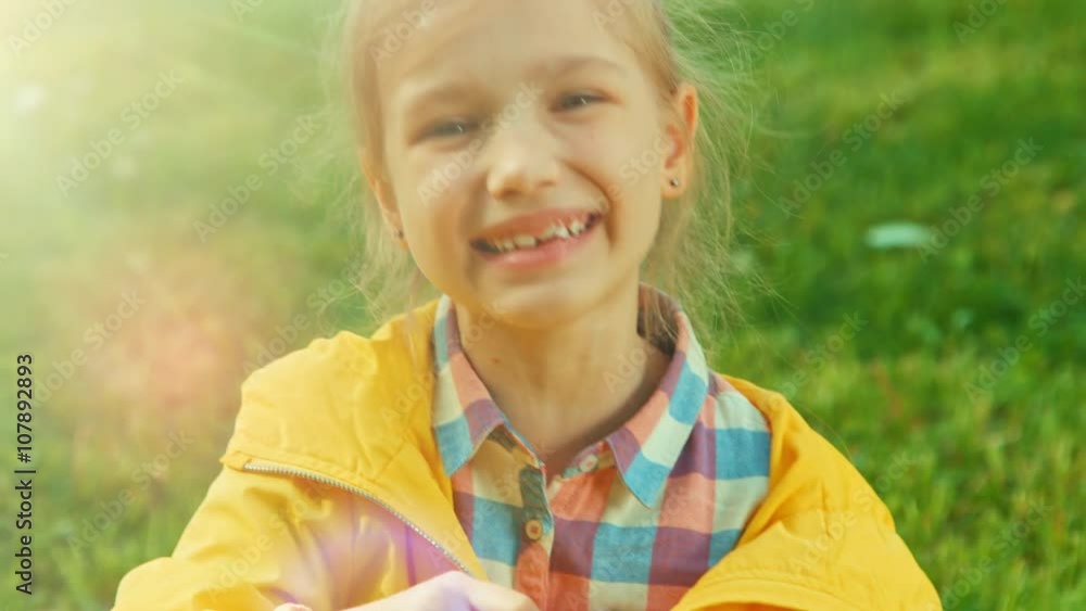 Closeup portrait child blowing soap bubbles and laughing at the camera. Sunlight and Lens flare Closeup portrait child blowing soap bubbles and laughing at the camera. Sunlight and Lens flare