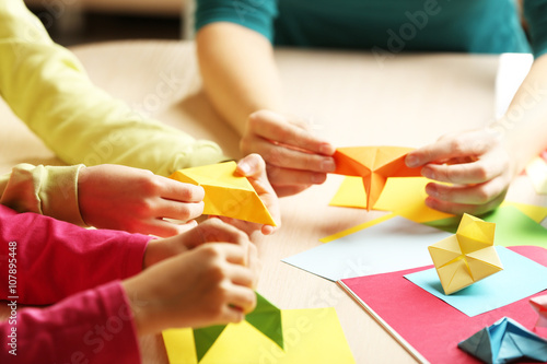 Children making swan with coloured paper