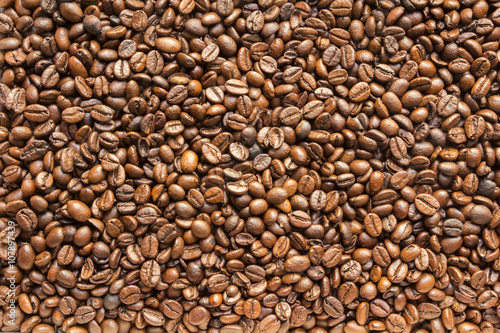 the texture of the coffee beans roasted Brown background
