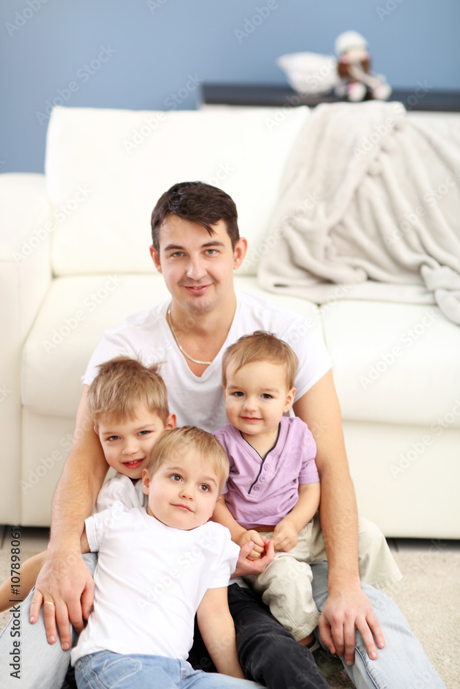 Family concept. Father with sons are playing in the room Family concept. Father with sons are playing in the room