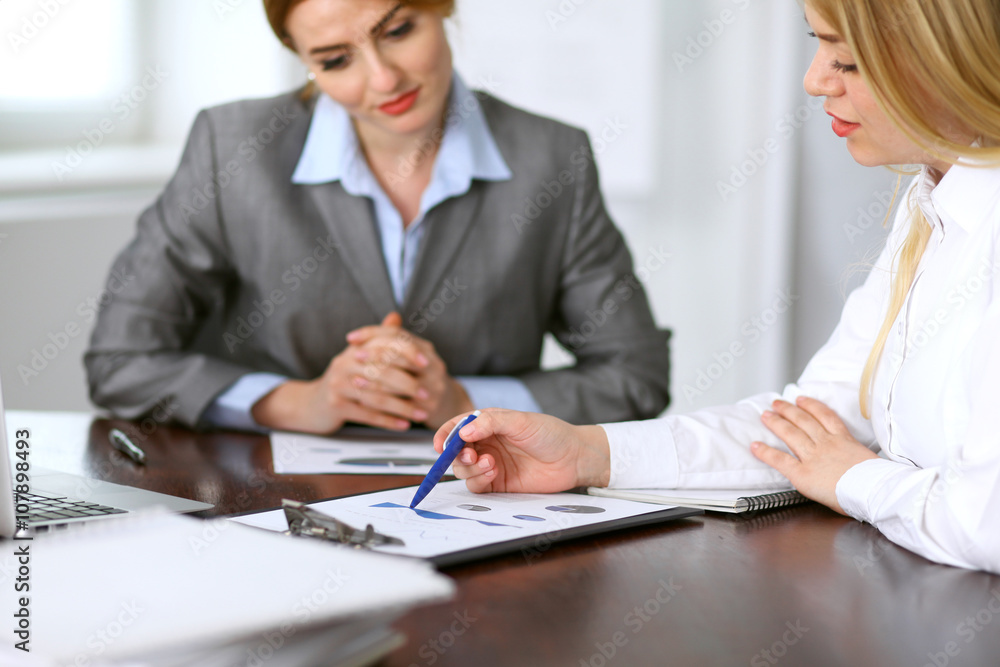 Close up of unknown business people at meeting discussing financial results Close up of unknown business people at meeting discussing financial results