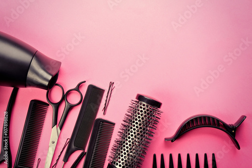 Fototapeta Naklejka Na Ścianę i Meble -  Hairdresser set with various accessories on pink background