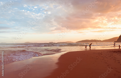 Fototapeta Naklejka Na Ścianę i Meble -  Active people walking on beach in Buzios Brazil