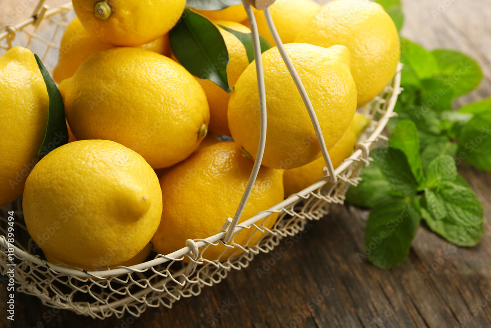 Fresh lemons in wicker basket closeup