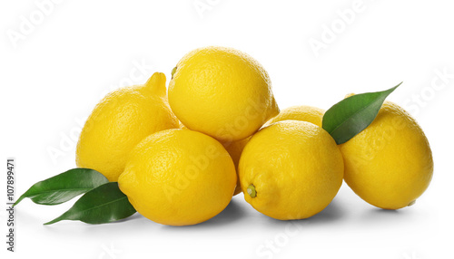 Fresh lemons with green leaves isolated on white