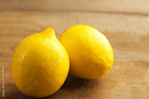 Fresh lemons on wooden background