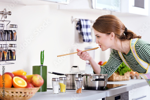 Young woman cooking in the ...