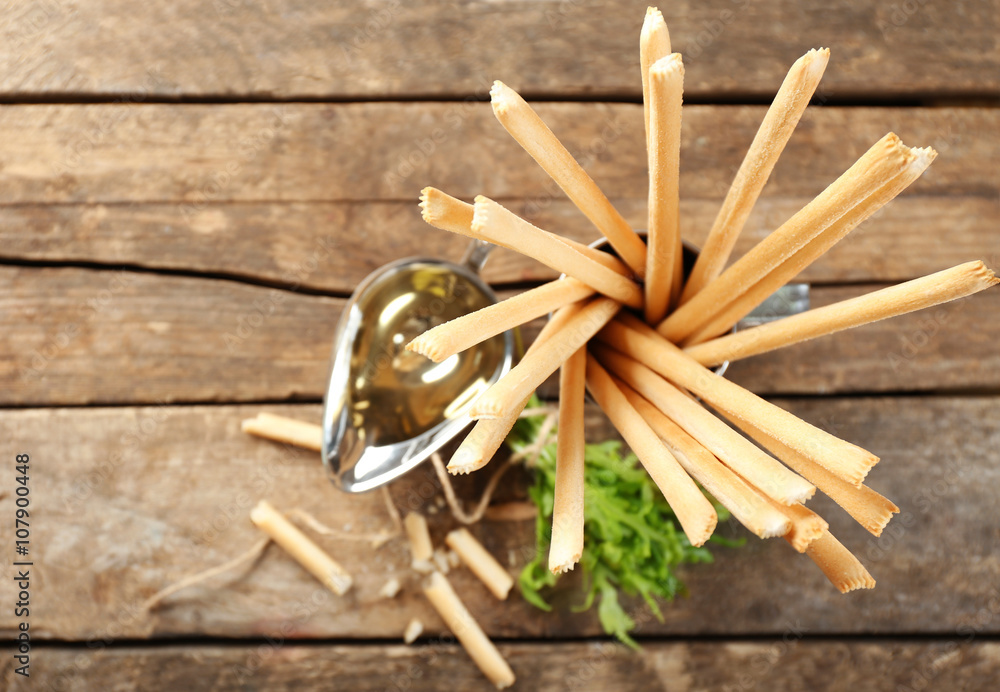 Bread sticks with arugula and oil, closeup Bread sticks with arugula and oil, closeup