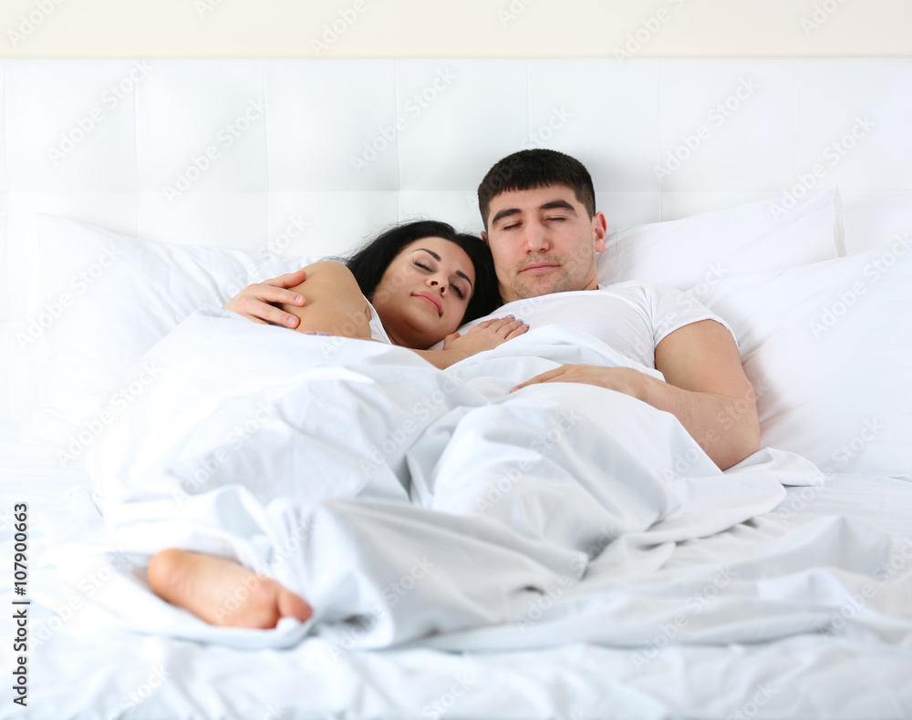 Fototapeta premium Lovely couple sleeping in white bed