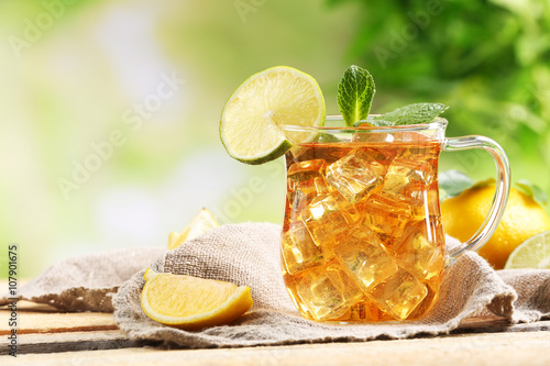 Glass of iced tea with lemon on a sackcloth