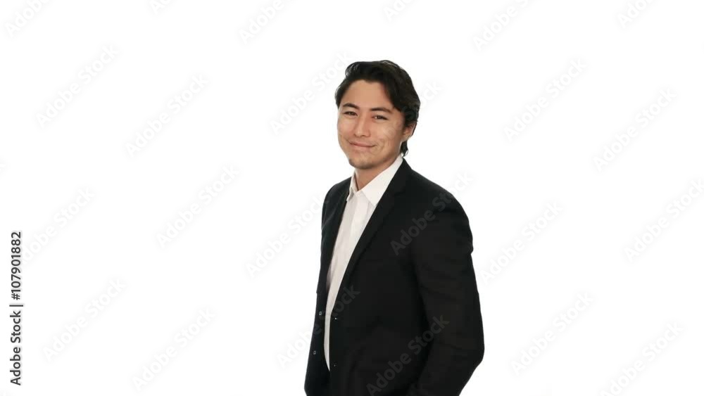 Adult businessman wearing a black suit and white shirt, standing against a white background with a big smile on his face. Video shot in 4K. Adult businessman wearing a black suit and white shirt, standing against a white background with a big smile on his face. Video shot in 4K.