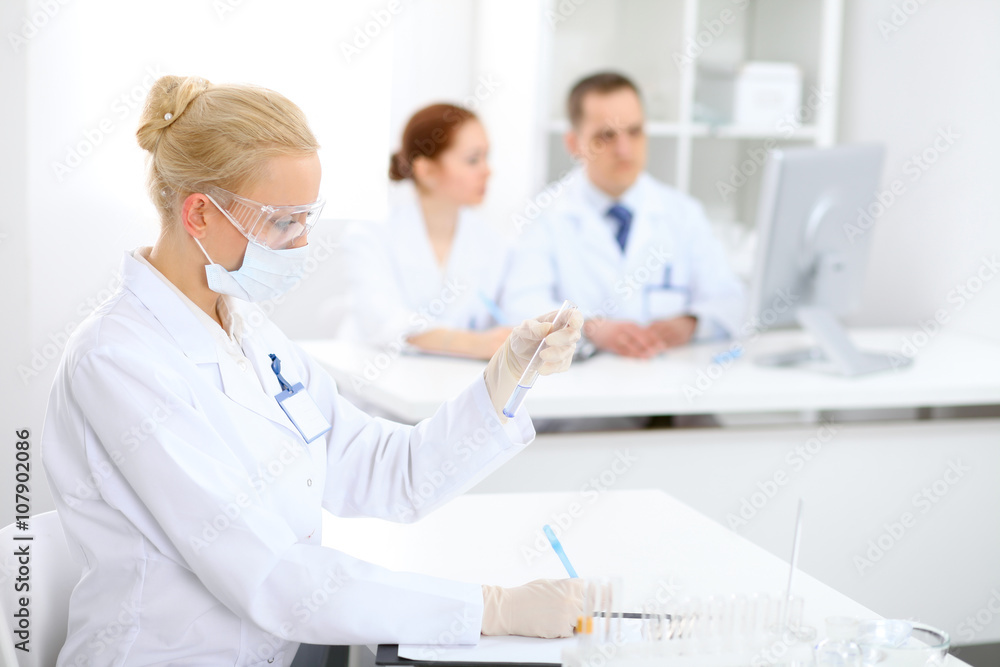Scientific research team with clear solution in laboratory Scientific research team with clear solution in laboratory
