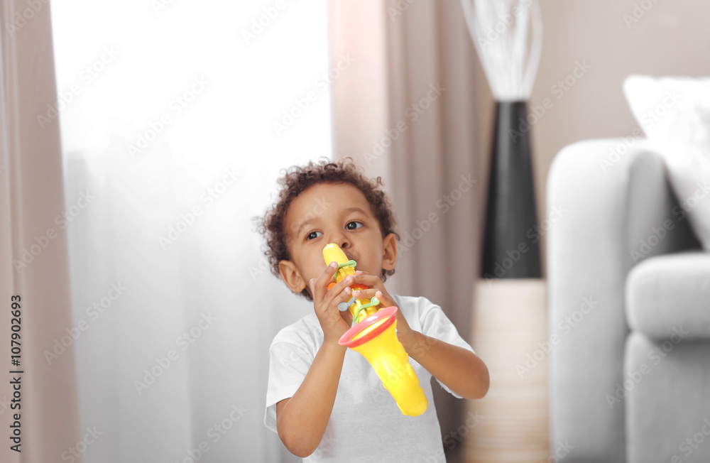 Little boy playing with musical toy on the floor Little boy playing with musical toy on the floor