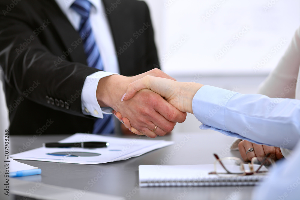 Business people shaking hands, finishing up a meeting Business people shaking hands, finishing up a meeting