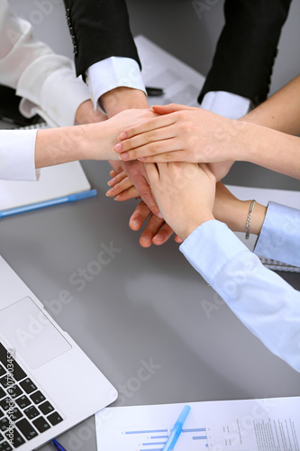 Business people group joining hands and representing concept of friendship and teamwork