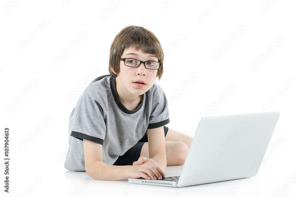 young boy in grey t-shirt with laptop young boy in grey t-shirt with laptop