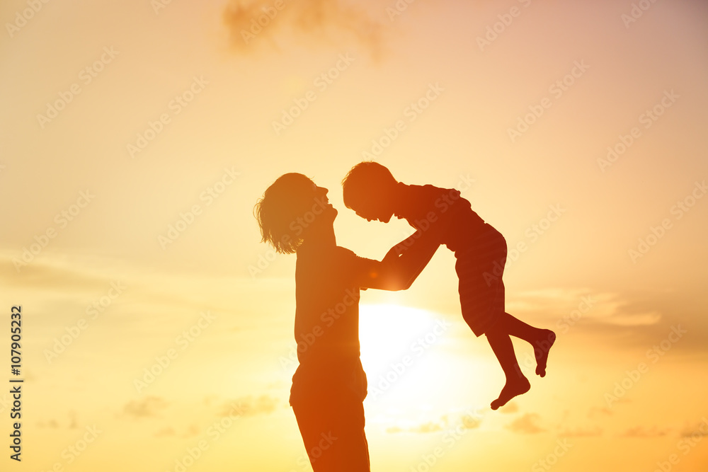 father and little son silhouettes play at sunset father and little son silhouettes play at sunset