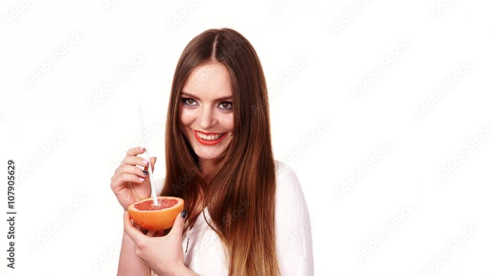 Woman holds grapefruit drinking juice from fruit 4K Woman holds grapefruit drinking juice from fruit 4K