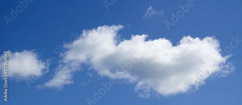 Big white heap clouds against a blue sky. © Gray wall studio
