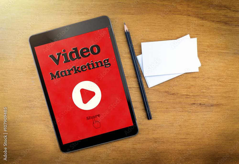 Video Marketing on mobile device screen with pen and business ca