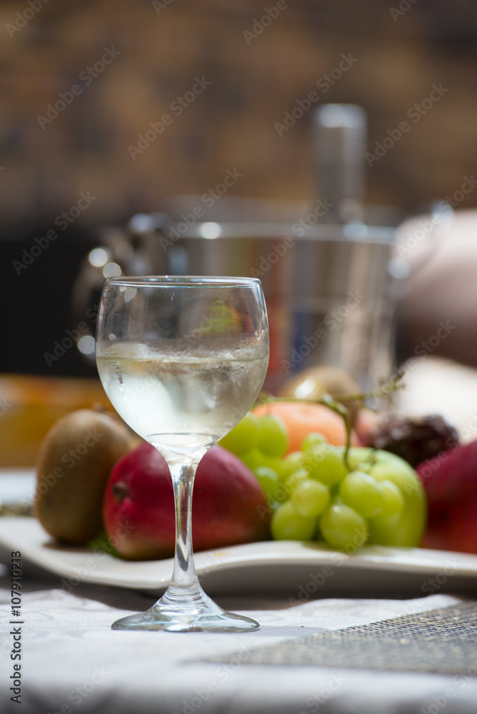 Ice bucket, bottle and glass of white wine Ice bucket, bottle and glass of white wine