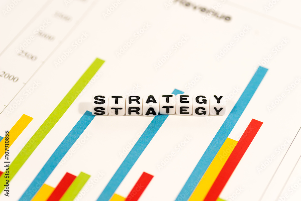 Colorful charts with STRATEGY on white cube Colorful charts with STRATEGY on white cube