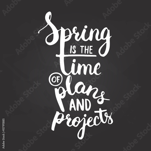 Hand drawn chalk typography lettering phrase Spring is the time of plans and projects on the black chalkboard background