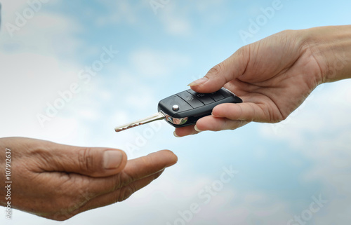 hand holding a key and blue sky