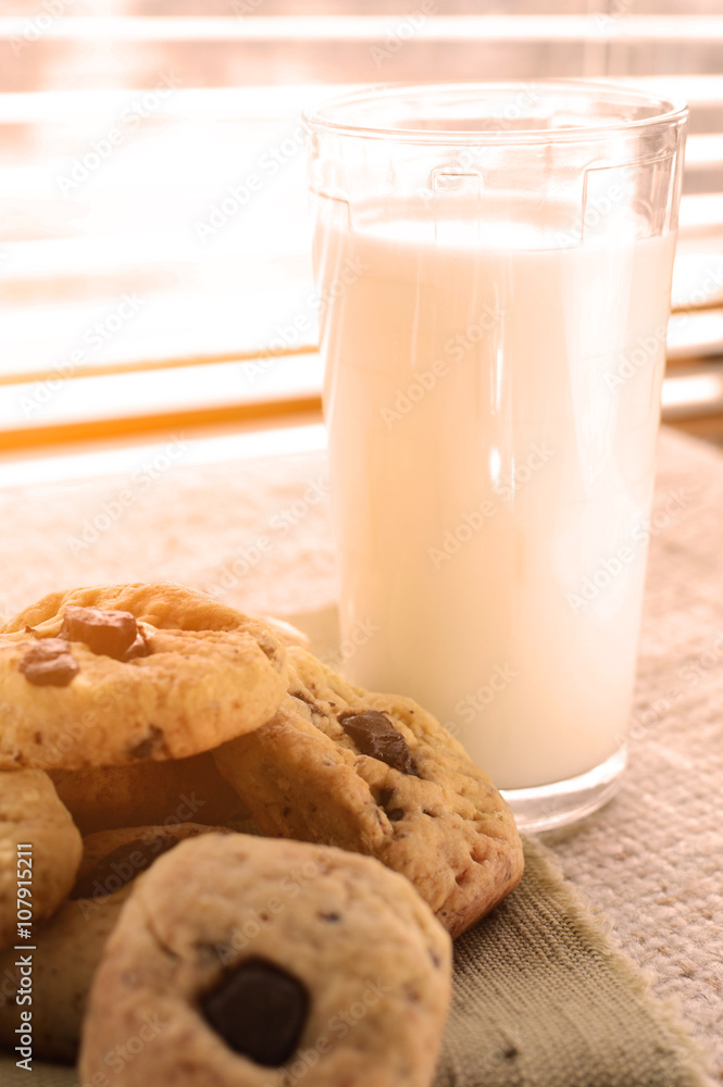 glass of milk and chocolate chip cookies at the window glass of milk and chocolate chip cookies at the window