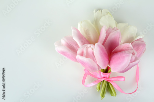 Fototapeta Naklejka Na Ścianę i Meble -  pink and white tulips are associated with pink ribbon on white isolated background