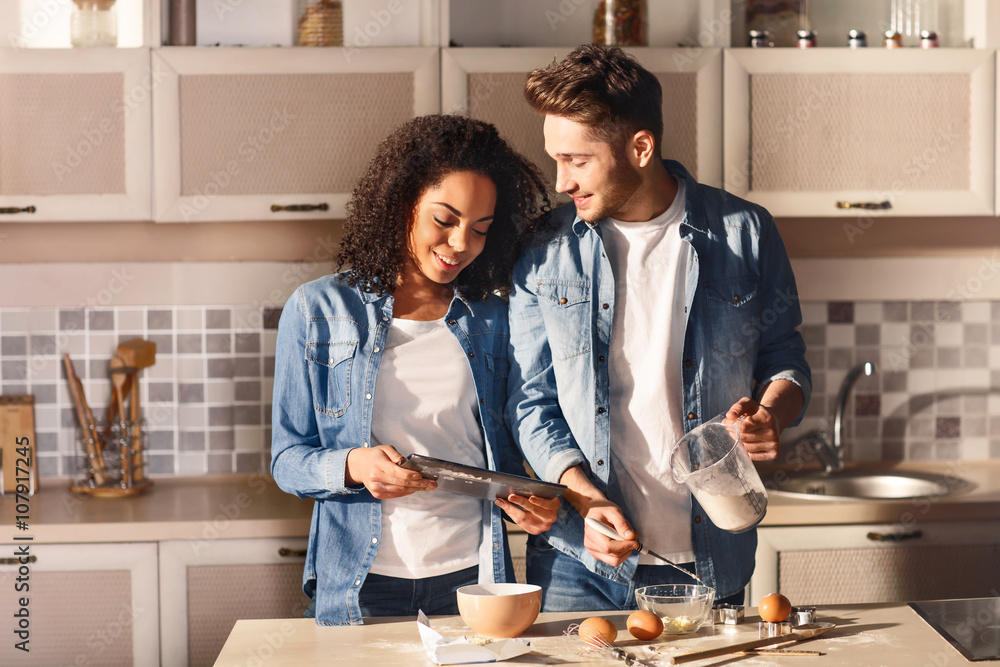 Positive couple cooking together Positive couple cooking together