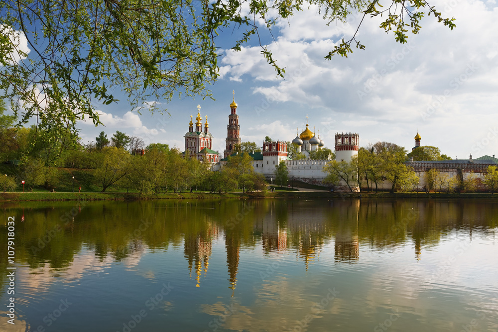 Novodevichy convent with the reflection in the lake at sunset