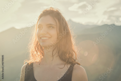 Young smiling blonde hair woman portrait on sunset in nature